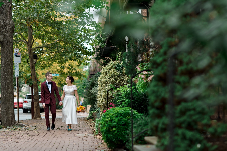 A wedding couple walk along the streets in the historic section of Philadelphia.